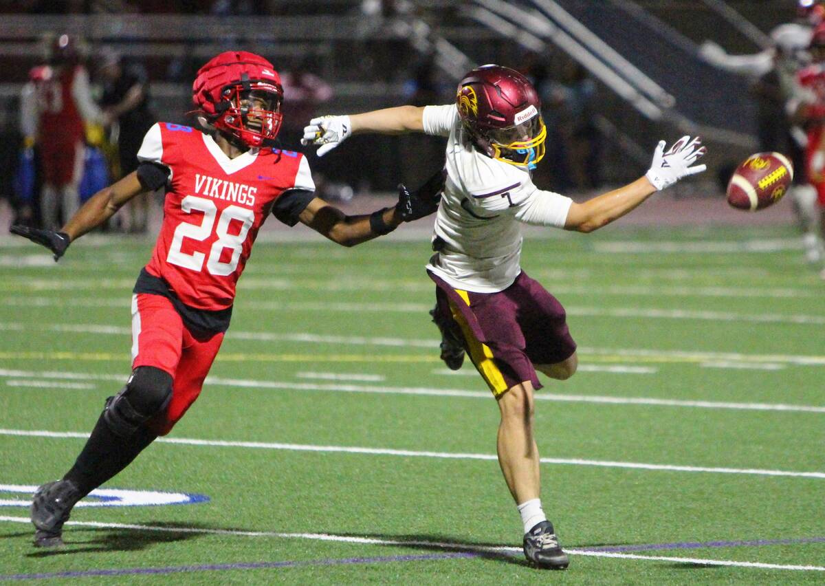 Pahrump Valley’s Ryan Hamlin stretches toward a pass with a Valley defender alongside him dur ...