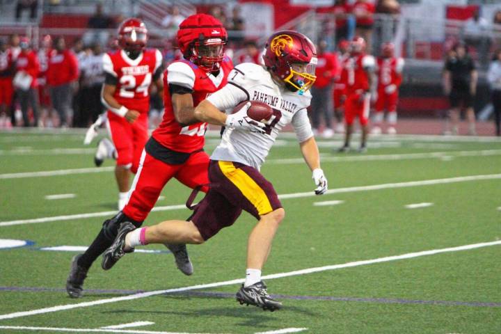 Pahrump Valley’s Ryan Hamlin carries the ball as a Valley defender pursues him during the Tro ...