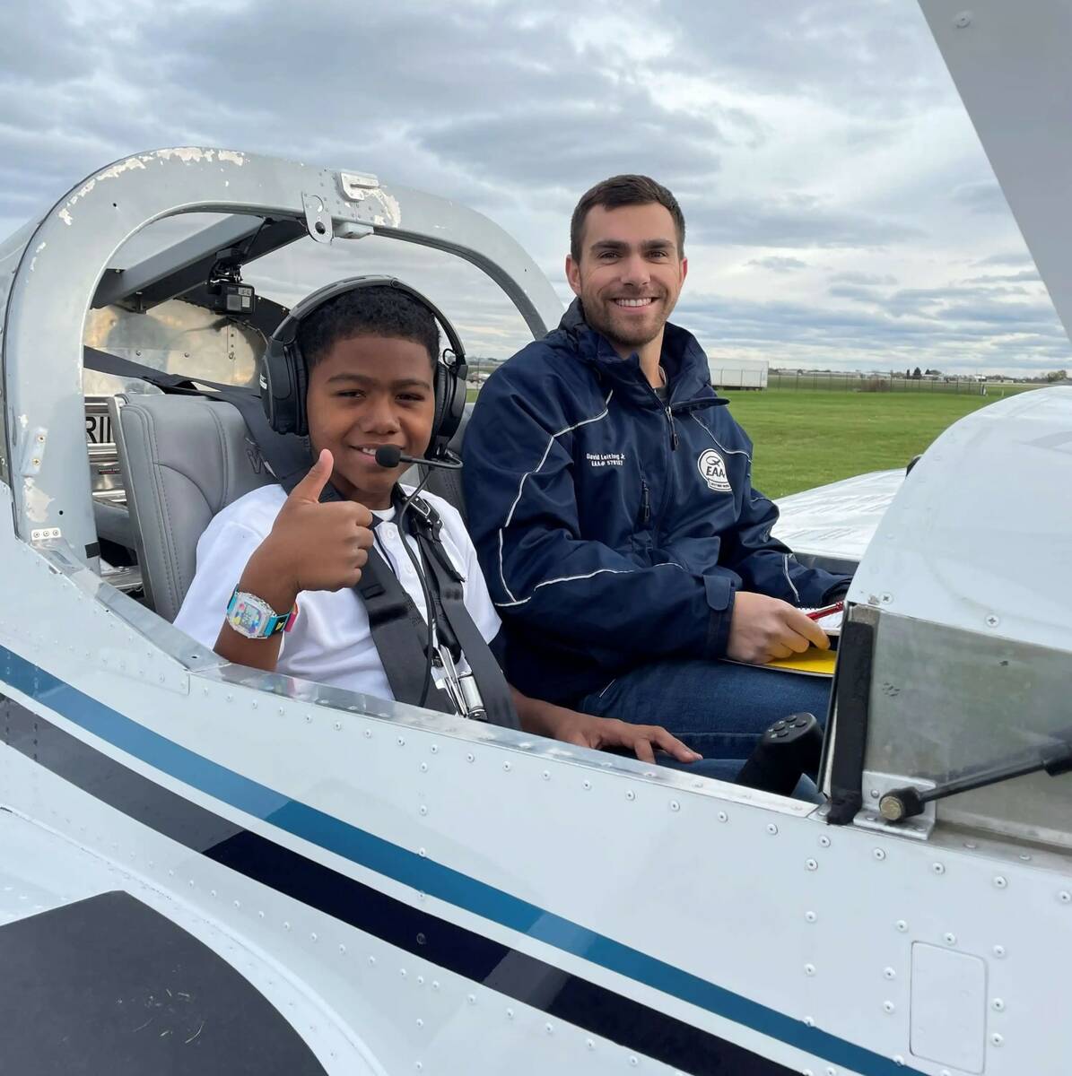 A Young Eagle gives the thumbs up from his seat in the airplane before his flight begins. The m ...