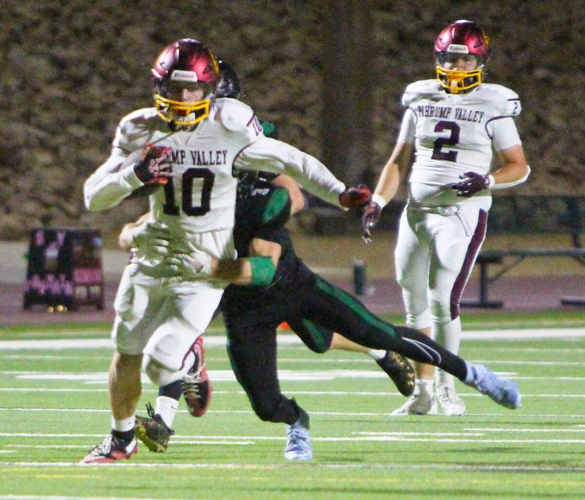 Pahrump Valley’s Lucas Gavenda carries the ball as a Virgin Valley defender moves to bring hi ...