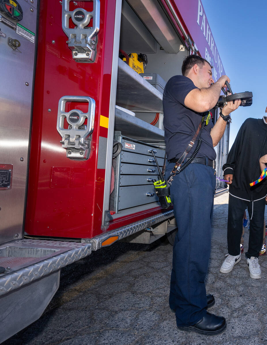 This firefighter showed the children all of the different gear and tools they use in their work ...