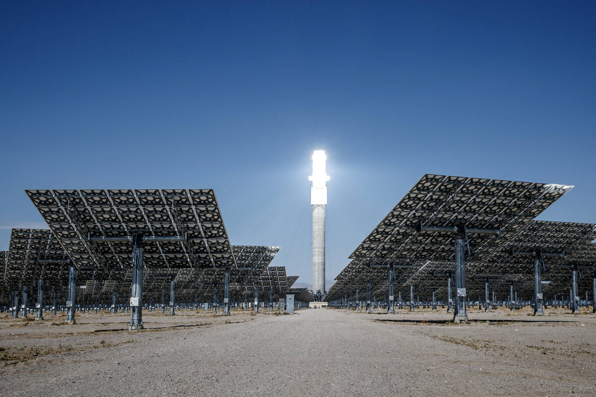 Sunlight heats molten salt that flows through a 640-foot receiver tower, causing the top to glo ...
