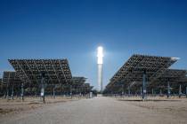 Sunlight heats molten salt that flows through a 640-foot receiver tower, causing the top to glo ...