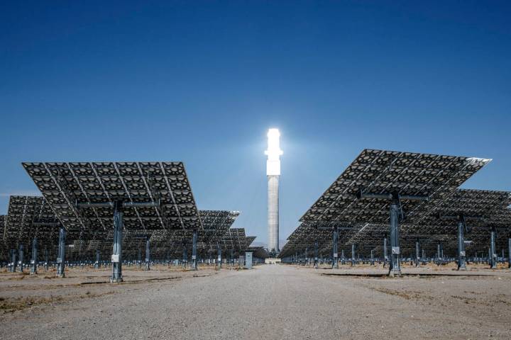 Sunlight heats molten salt that flows through a 640-foot receiver tower, causing the top to glo ...