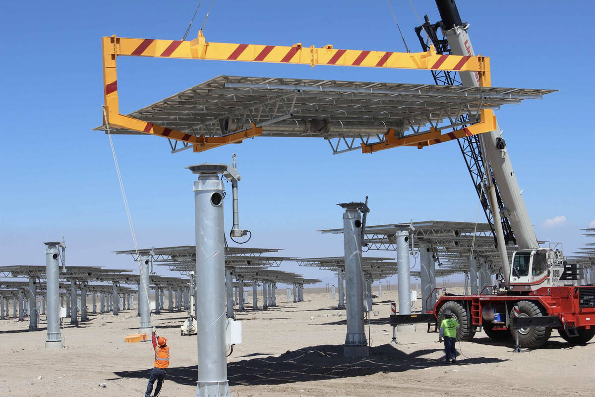Workers install heliostat panels at the Crescent Dunes facility in Tonopah in an undated photo. ...