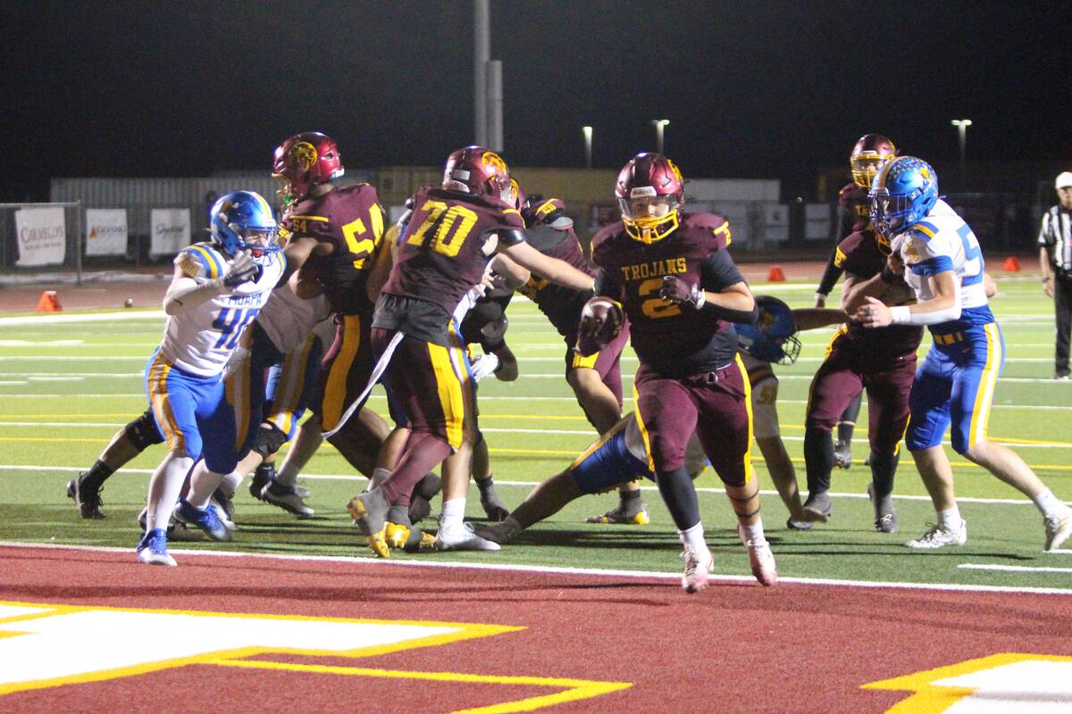 Pahrump Valley’s Preston Dockter carries the ball in the end zone during the Trojans’ homec ...