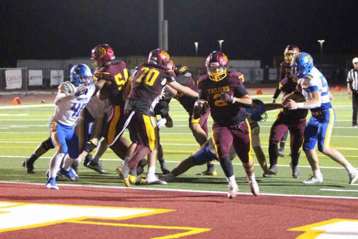 Pahrump Valley’s Preston Dockter carries the ball in the end zone during the Trojans’ homec ...