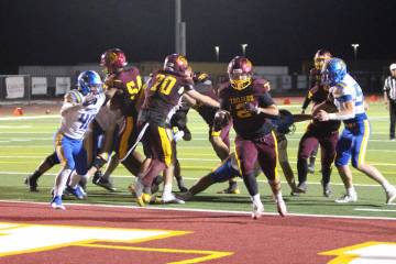 Pahrump Valley’s Preston Dockter carries the ball in the end zone during the Trojans’ homec ...