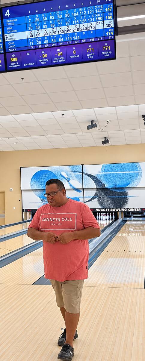 David Bishop stands beneath the scoreboard displaying his no-tap 300 during the Pahrump Valley ...