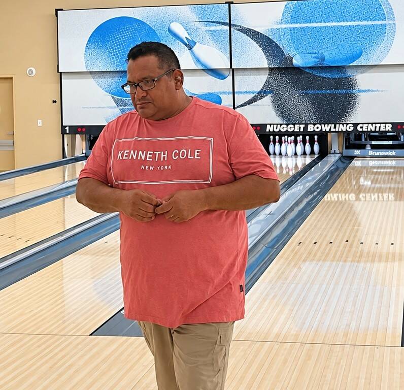David Bishop stands beneath the scoreboard displaying his no-tap 300 during the Pahrump Valley ...