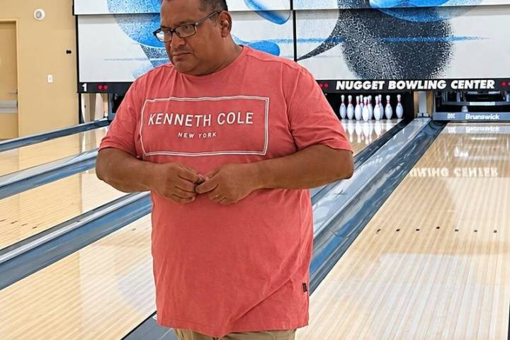 David Bishop stands beneath the scoreboard displaying his no-tap 300 during the Pahrump Valley ...