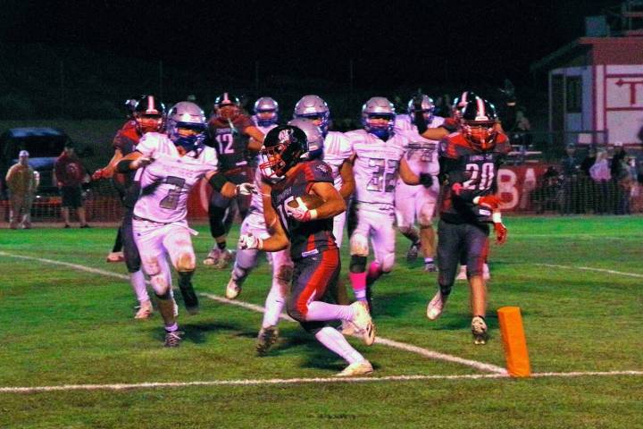 Tonopah’s Dustin Otteson (25) carries the ball into the end zone against Pahranagat Valley du ...