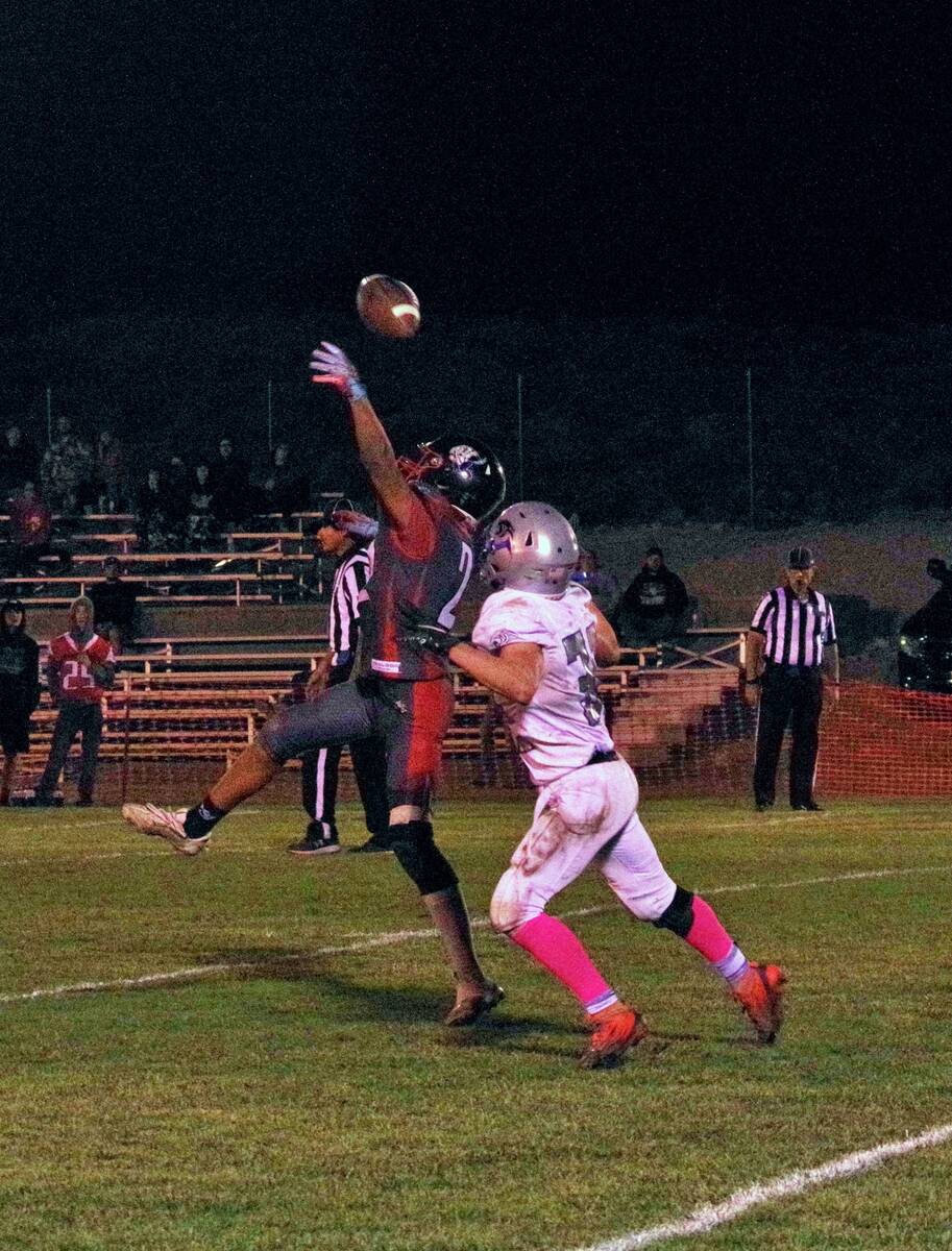 Tonopah’s Ammon Campos (2) reaches for a pass while battling a Pahranagat Valley defender dur ...
