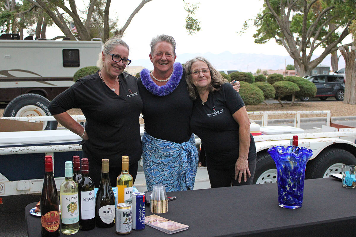 ACORN Executive Director Kathie McKenna, center, poses with The Wine Down owner Joelle Bolton, ...