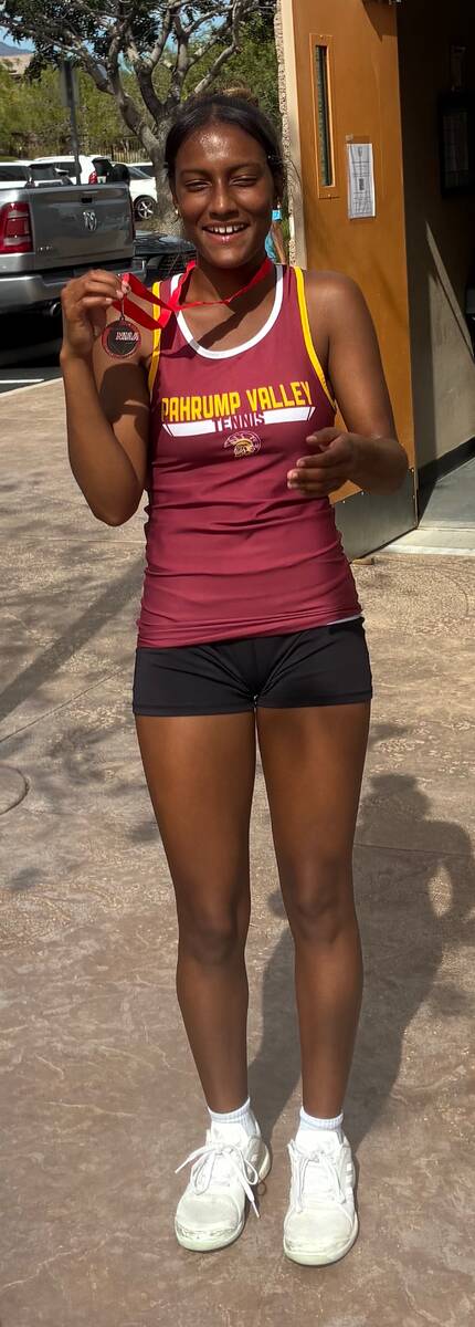 Pahrump Valley senior Chanel Anthony shows her medal after finishing second in girls singles at ...