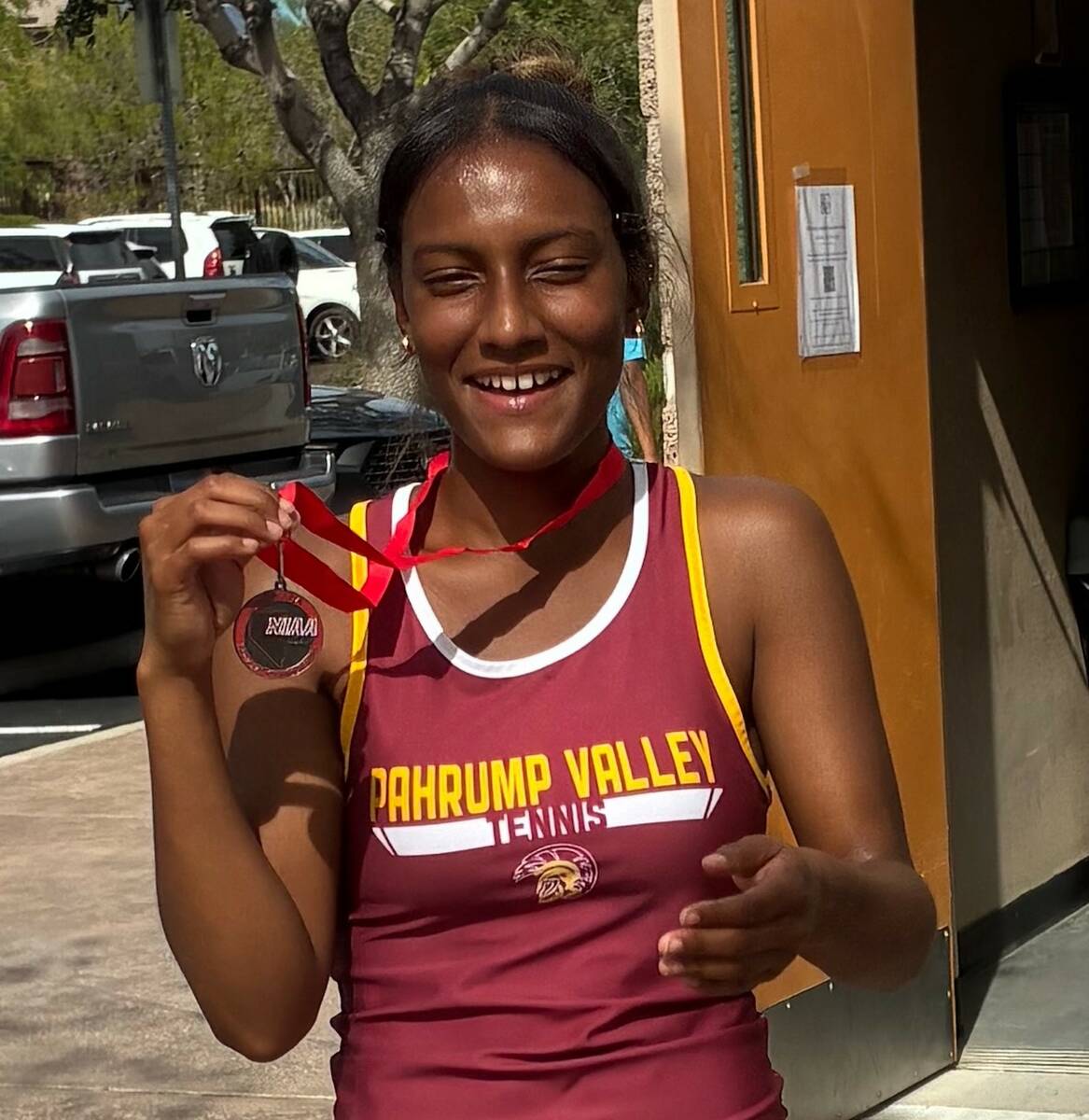 Pahrump Valley senior Chanel Anthony shows her medal after finishing second in girls singles at ...