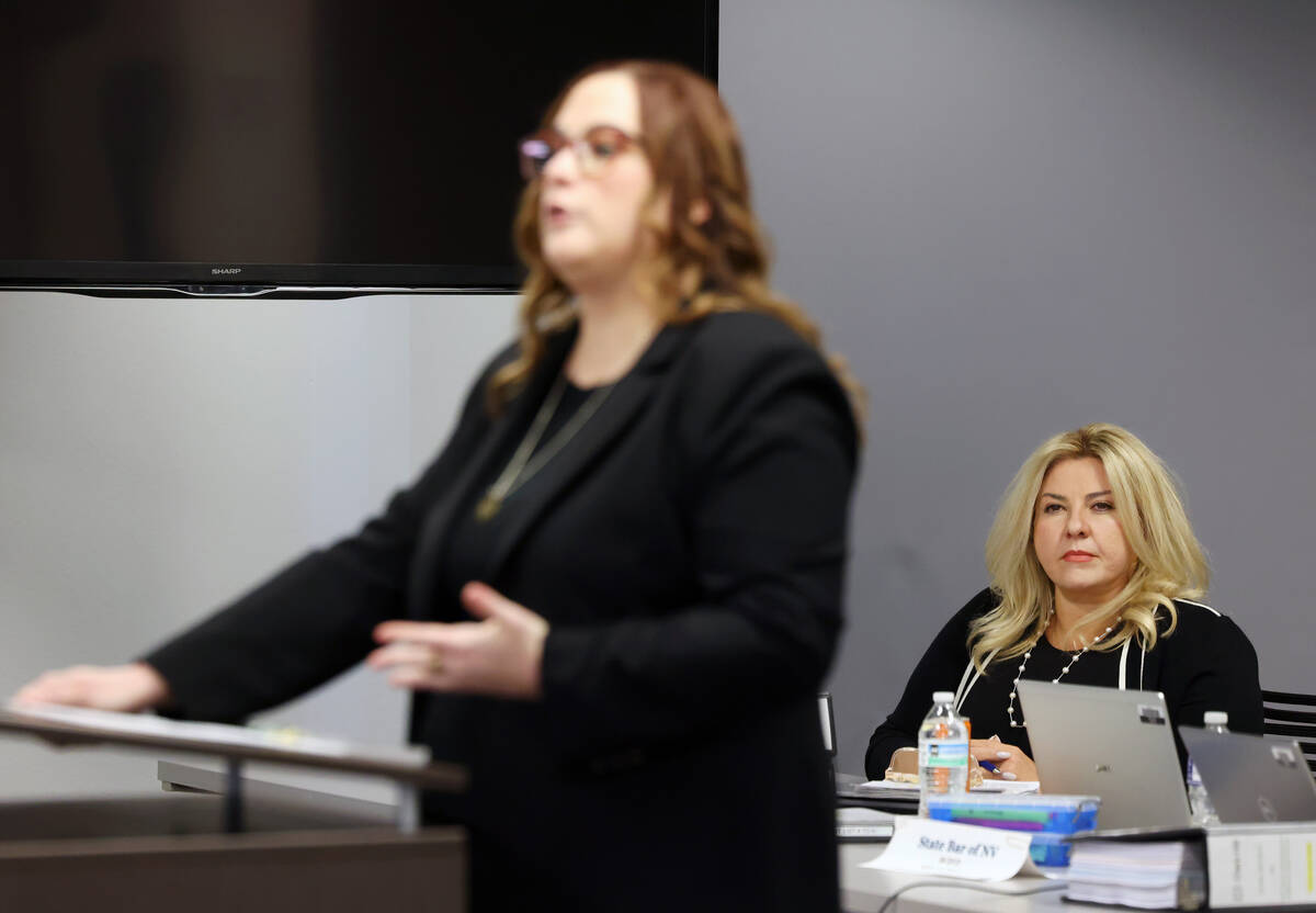 Suspended Pahrump Justice of the Peace Michele Fiore, right, listens as her attorney, Gia Marin ...
