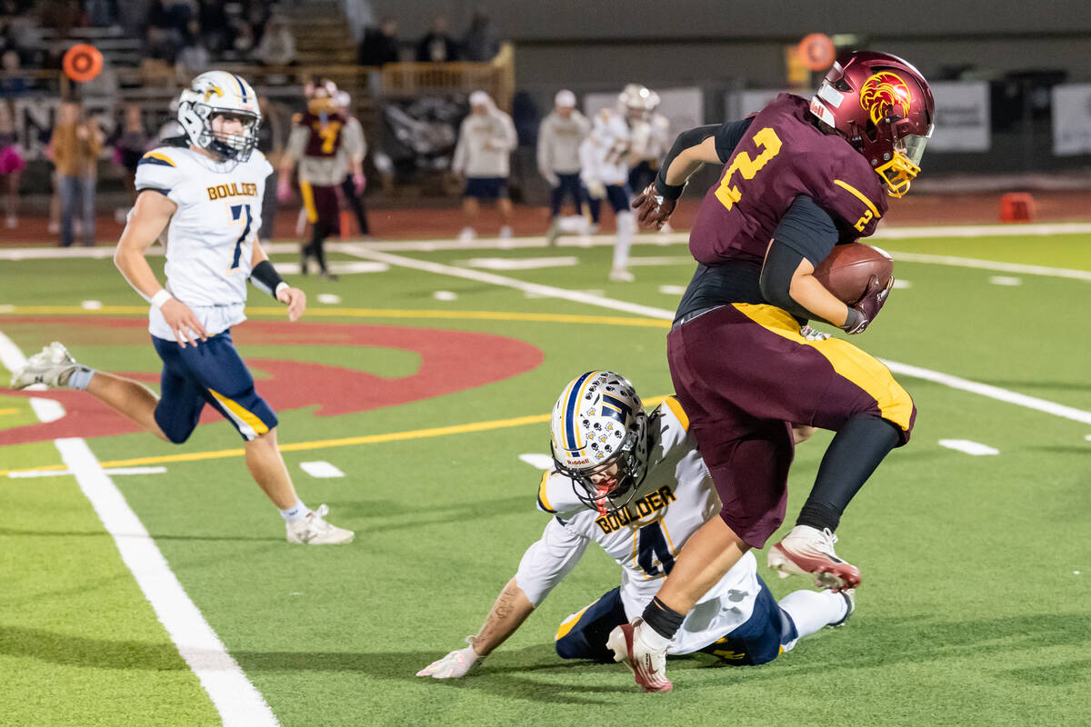 Pahrump Valley’s Preston Dockter (2) carries the ball as a Boulder City defender attempts a t ...